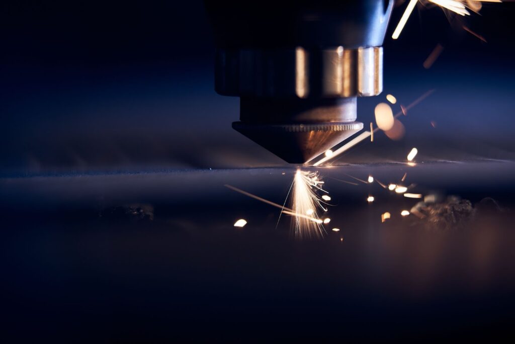 A CNC machine casts sparks against the metal it is cutting.