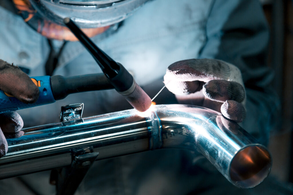 Alt text: A close-up image of a welder performing TIG welding.