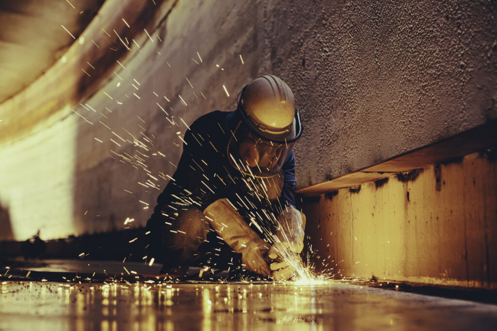 Sparks fly as a welder works on a sheet metal project.